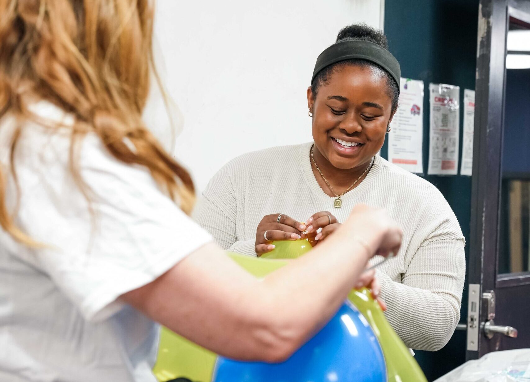 A dedicated volunteer holds a balloon during the 2025 MSV Associate Board 3-on-3 Willie Morris Basketball Tournament.